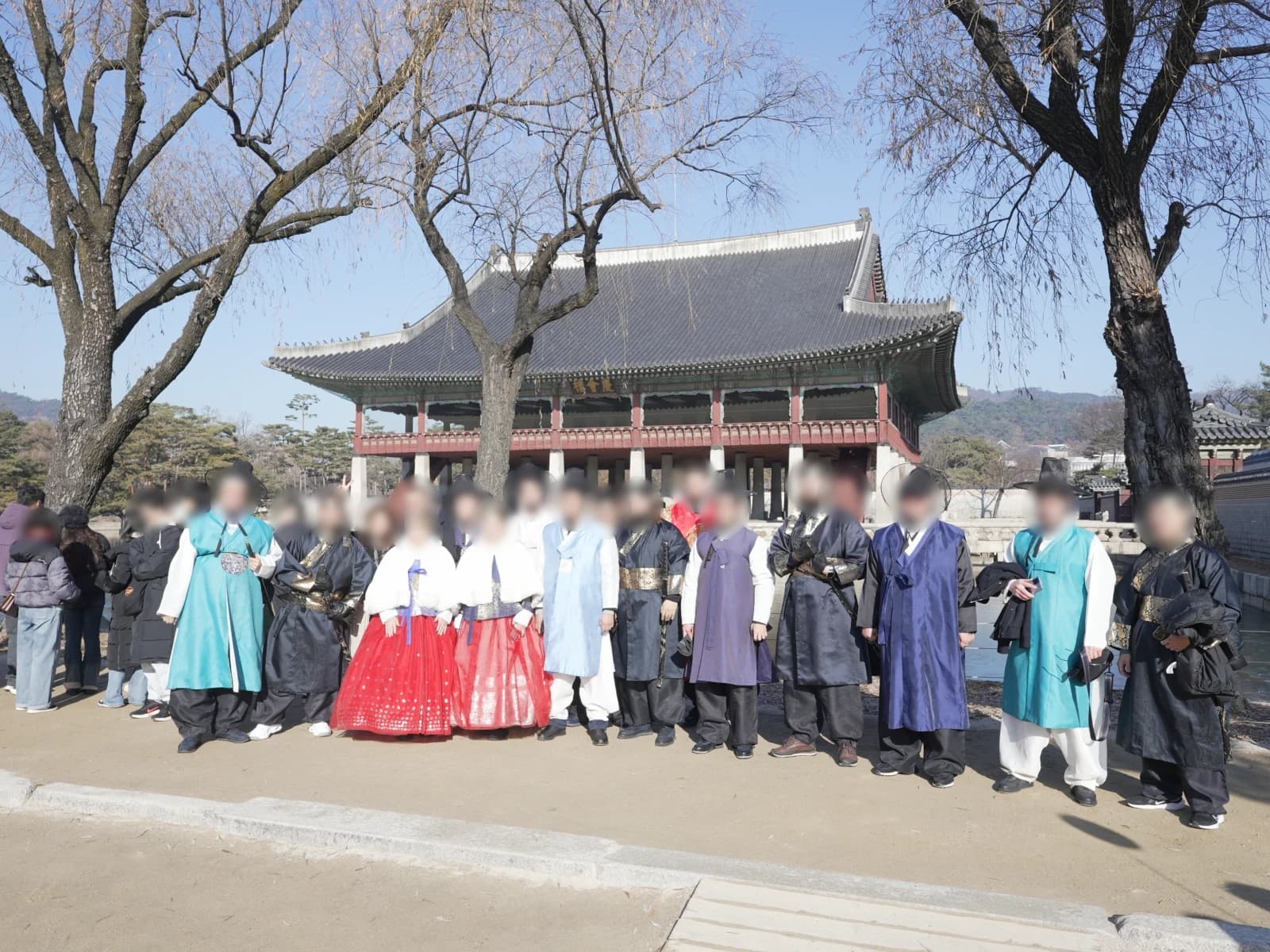 Central Asian partners in hanbok at Gyeongbokgung Palace, a second group during the cultural experience