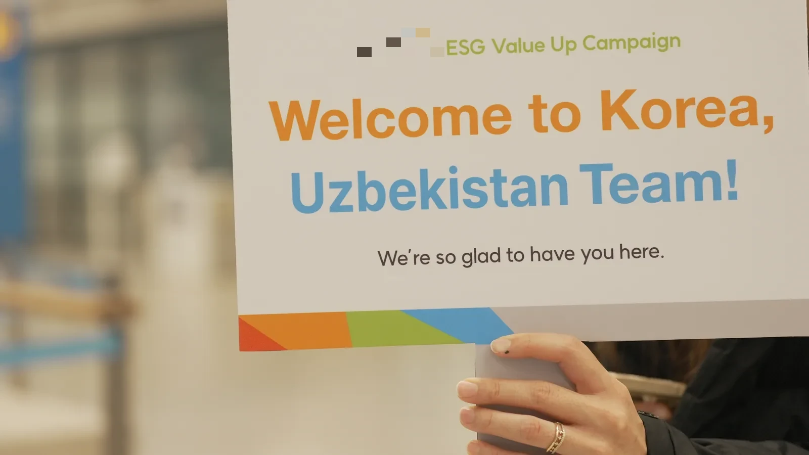 Welcome reception at Incheon Airport — operations team greeting the Central Asian delegation with signage and welcome kits